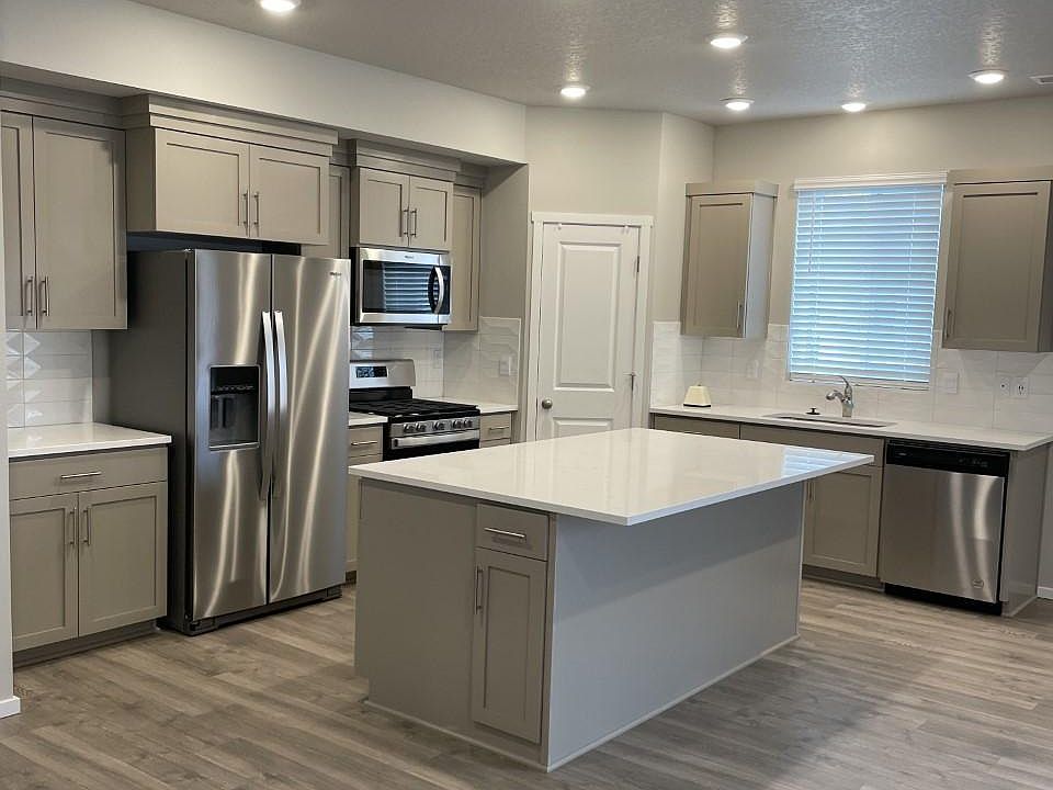 Kitchen with quartz countertops, full back splash, gas stove, brand new stainless appliances.