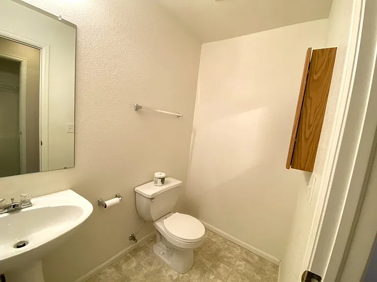 Downstairs bathroom by garage entry door.