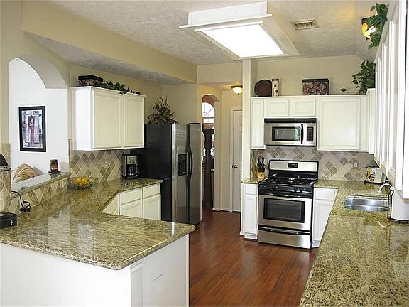 Phenomenal chef's dream kitchen, complete with granite countertops, stainless appliances, & spacious