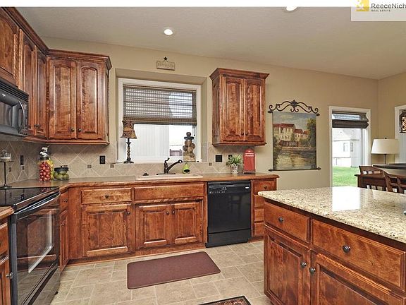 Spacious granite work island with breakfast bar seating. Deep window for decor or herb garden