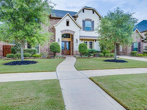 This home is gorgeous inside and out with detailed brick and stone work, nicely landscaped front and back yards, and additional parking in the "auto court".  Come see inside...you won't be disappointed.