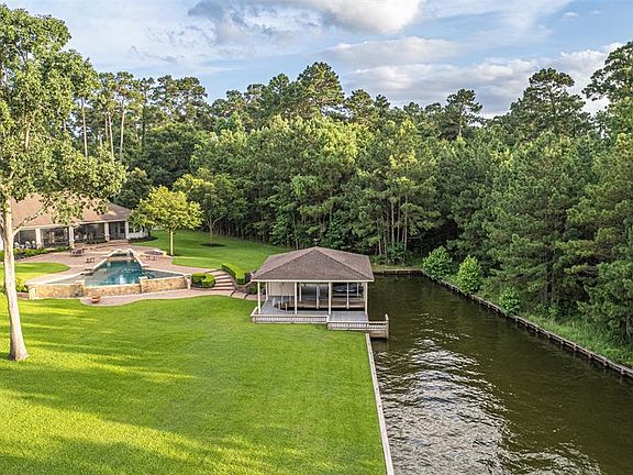 Image 5: OPEN WATER with a spectacular boat house with boat lift, TWO jet ski lifts, and storage closet all tucked into a small cove for protection from wind and waves...