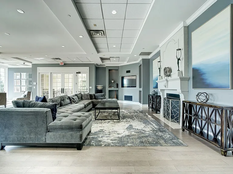 Expansive Resident Clubhouse with Plush Seating Areas, Cozy Fireplace, Balcony Area, and Bar