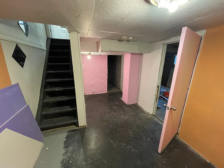 Stairs to kitchen (left), half bath (under stairs), Laundry hookups (straight) and garage entrydoor