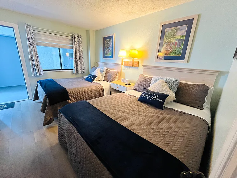 two queen size beds in the bedroom