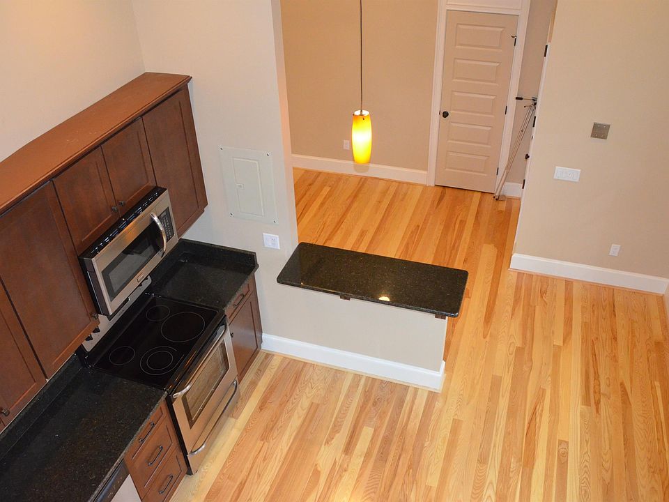 51 Allen 303 Living Room, Breakfast Bar, and Kitchen from top of spiral stairs