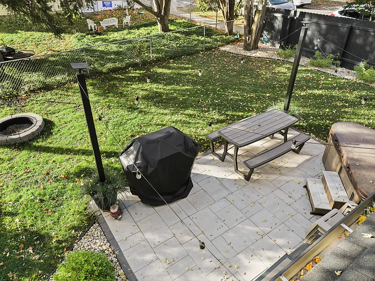 Backyard featuring a 12x18 patio, gas grill, picnic table, bistro chairs, and fire pit/chairs. The hot tub you see in the right corner is NOT available or on site for use.