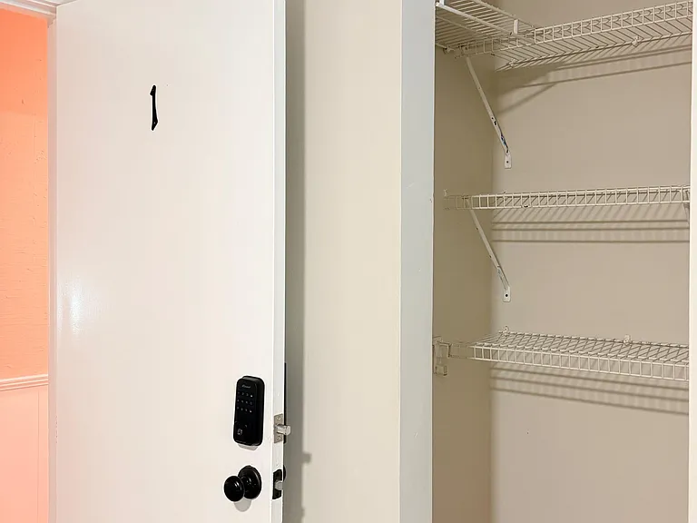 Spacious walk-in closet with multiple wire shelves for easy organization and extra storage off the main living area.