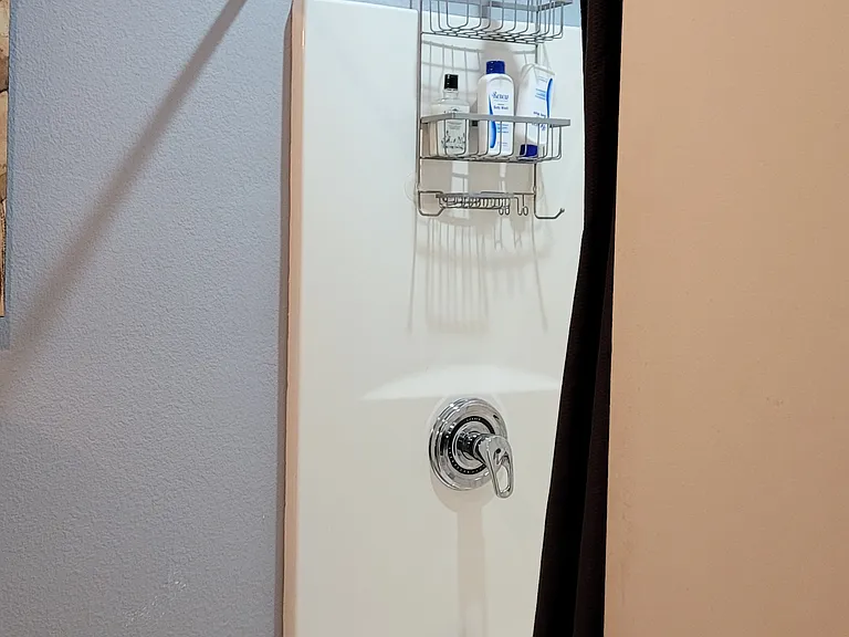 Linen closet is behind door in bathroom - view is of the tub/shower