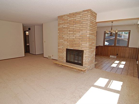 Wonderful natural lights in the living room with a brick fireplace
