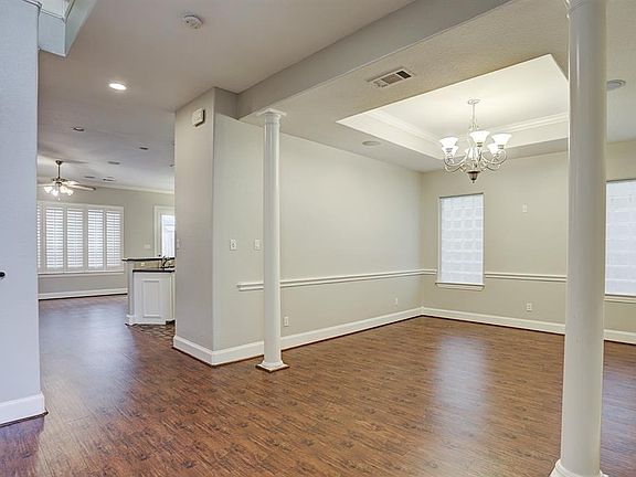 Large dining room graced with glass block windows and coffered ceiling.