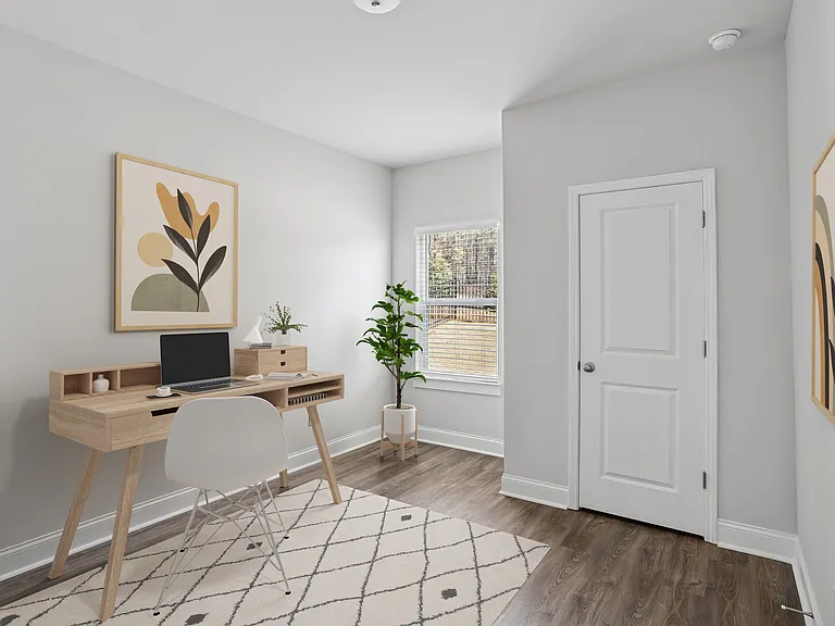 Primary bedroom with space for a desk and chair.