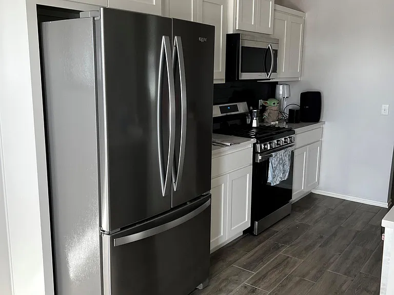 Stylish quartz countertops paired with a sleek, included refrigerator_ready for both everyday living and entertaining.