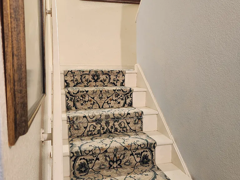 Step on padded, newly carpeted full size stairs to 4th floor living area with beach views!