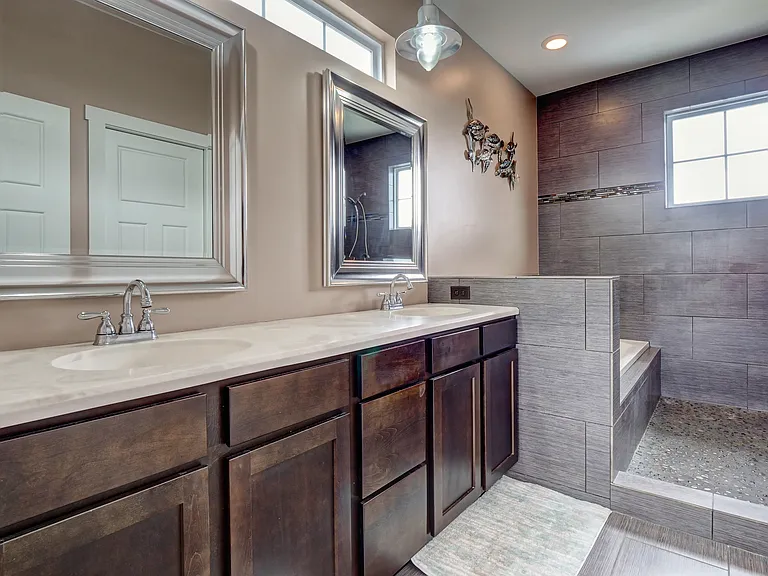 Upstairs Master Bathroom with double vanities, deep, soaking tub and pebble-floored shower w/ double shower heads
