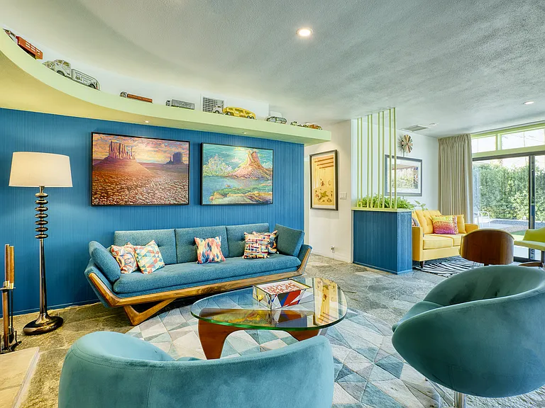 Gondola couch, bucket swivel chairs and Noguchi coffee table with view to TV den.