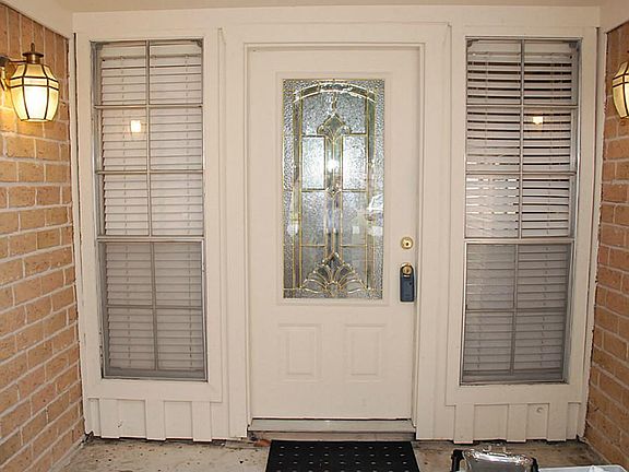 The charming courtyard brings you to a lovely leaded glass door