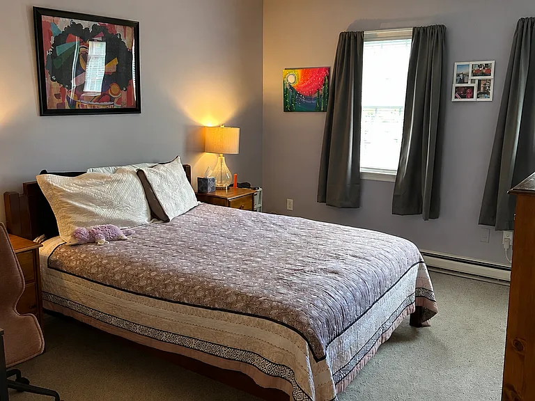 Bedroom with window and wall-to-wall carpet