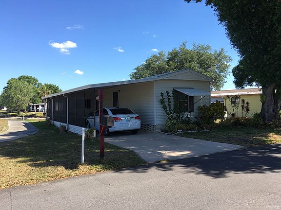 Front of Home w/ Attached Carport
