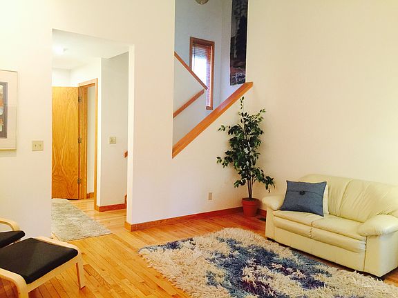Formal living room with view of open stairway to upper level.