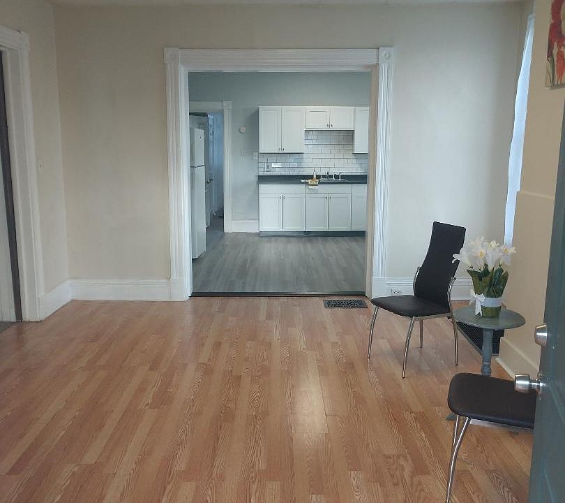 Front door looking into unit with family in front and then kitchen