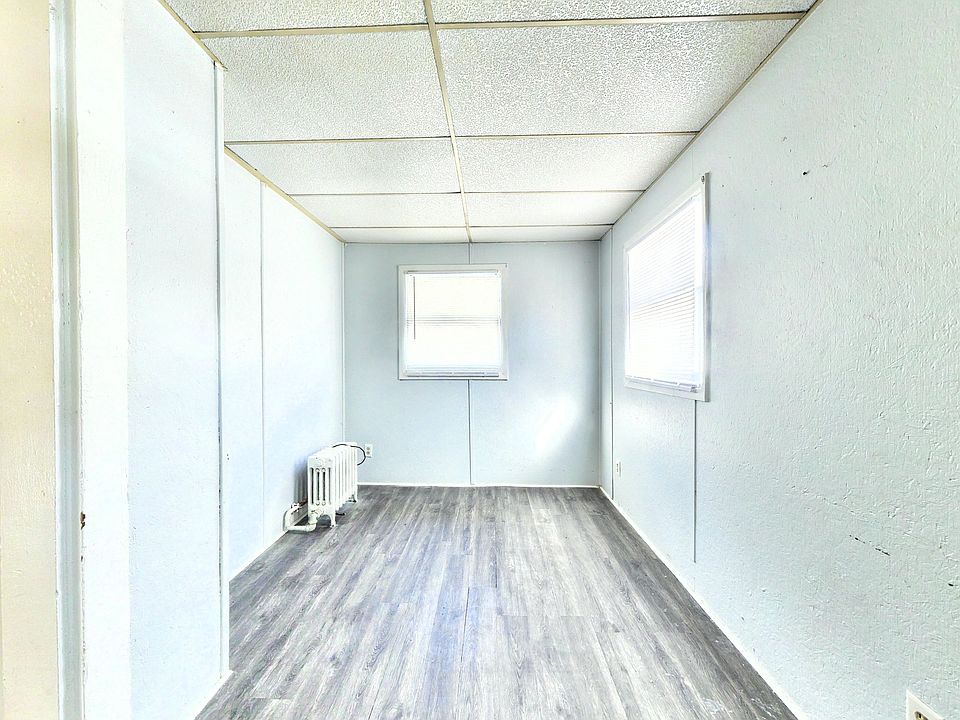 Features brand-new luxury vinyl flooring, ample natural lighting, and reliable radiator heating.