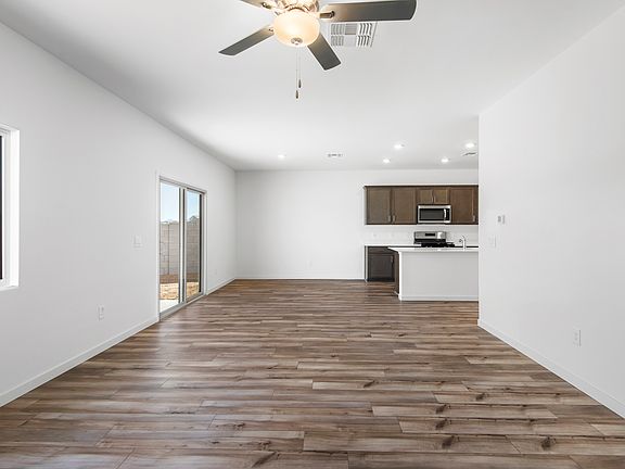 The kitchen and living room areas are a spacious open layout opening up to the back patio.
