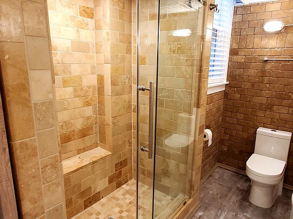 Renovated Bathroom:: Tiled Walk-in Shower, Frameless Sliding Shower Door, Inlay Basin Vanity, Bulkhead Light Fixtures, Brushed Stainless Conduit