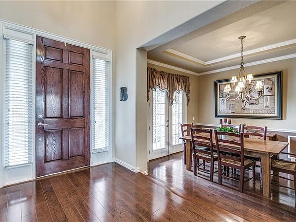 Beautiful entry with step down into the formal dining room. Notice the French doors in the formal dining room leading out to the large covered porch.