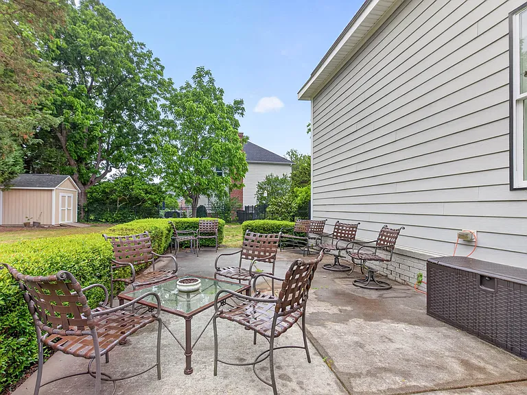 Manicured landscaping, fenced in backyard and large concrete patio