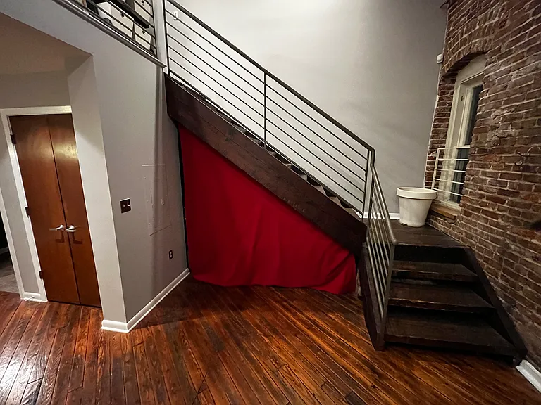 "Hidden" sleeping area under stairs