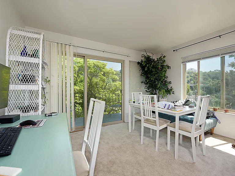 Living room and dining area with south and west view of Downtown Seattle, Space Needle, Lake Union, and east facing for balcony for morning sun into living area