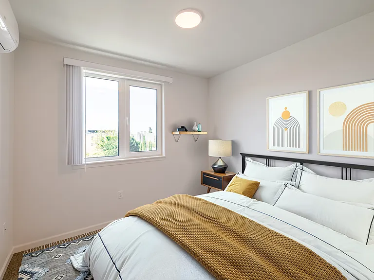 Bedroom B has plenty of light and a clean design.