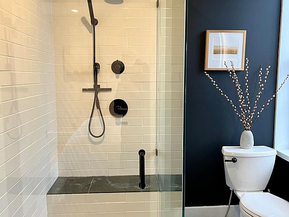 Newly remodeled custom bathroom honed slate tile, solid marble shower base, custom cabinetry.