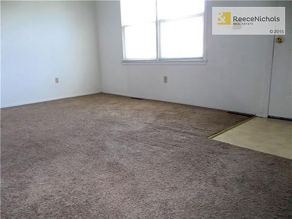 Living Room showing double windows, entry and newer carpet.