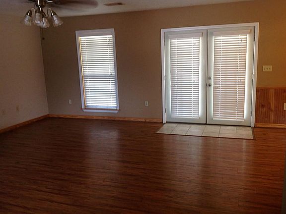 LIVING ROOM HAS HARDWOOD FLOORING AND FRENCH DOORS