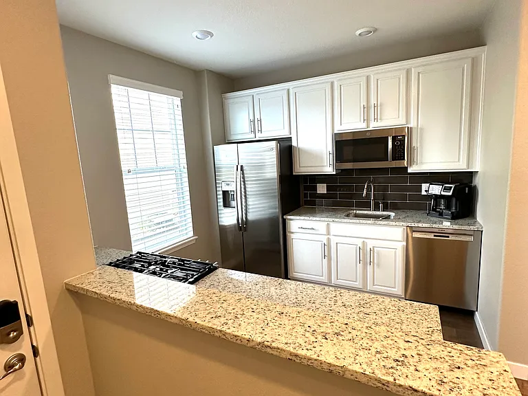 The welcoming front entry includes a convenient countertop for keys, mail, and other essentials, as well as a dedicated space to leave shoes.