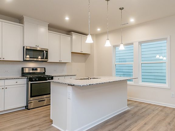 The sprawling kitchen island overlooks the living and dining areas.