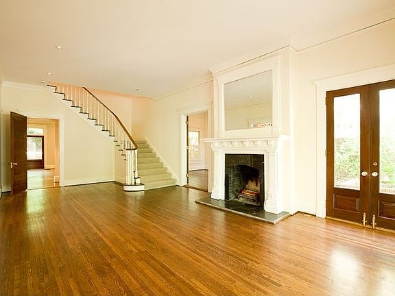 THE FORMAL LIVING ROOM HAS FRENCH DOORS WHICH OPEN TO A PRIVATE TERRACE