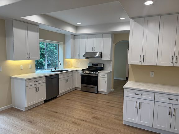 Kitchen with range/stove, dishwasher, refrigerator