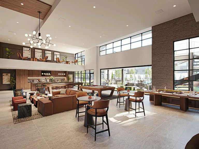 A spacious clubroom with game tables, lounge seating, and seamless indoor-outdoor flow.