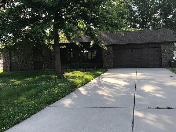Concrete driveway with a two car garage with electric door o