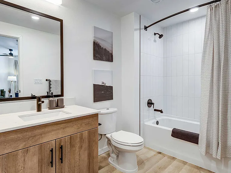 Clean lines, contemporary fixtures, and warm wood-style cabinetry bring a modern and comfortable feel to everyday routines.