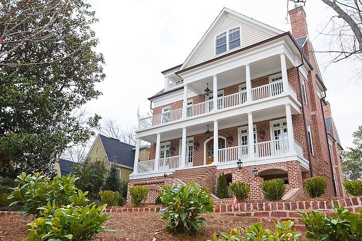 HOME IS SET ON A GENTLE HILL WITH GORGEOUS VIEWS FROM 3 LEVELS OF PORCHES