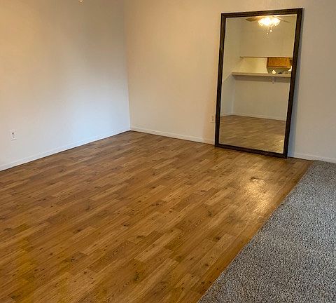 New floor and dining area adjacent the living room area. The mirror is no longer in the building.