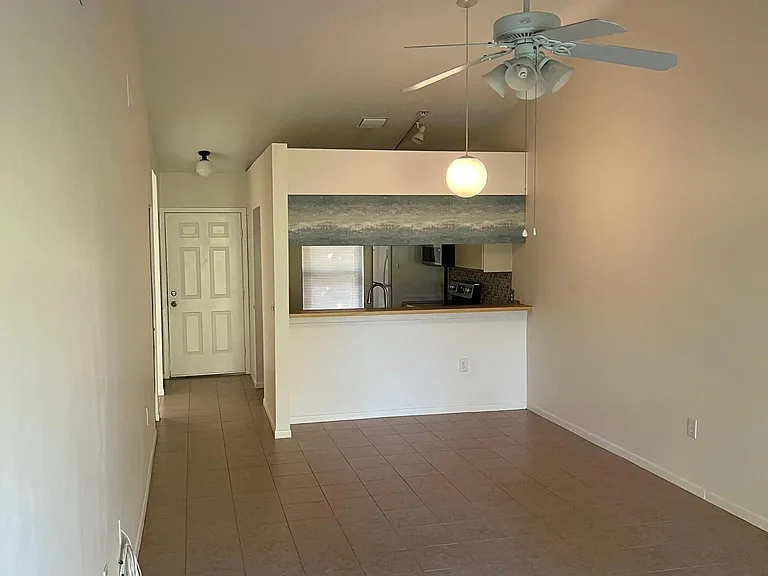 View from the sliding glass doors. Space for table with seating under globe light.