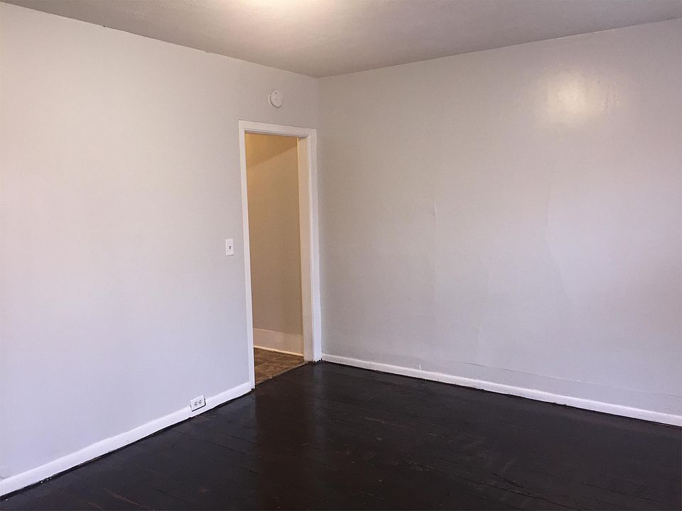 Original hardwood flooring has been freshly restored in the combined living/bedroom.