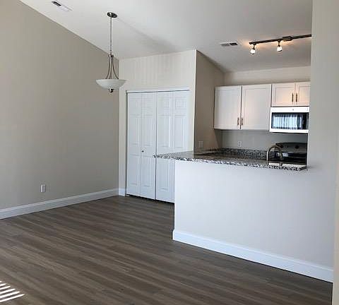 Vaulted ceilings over living room, dining and kitchen