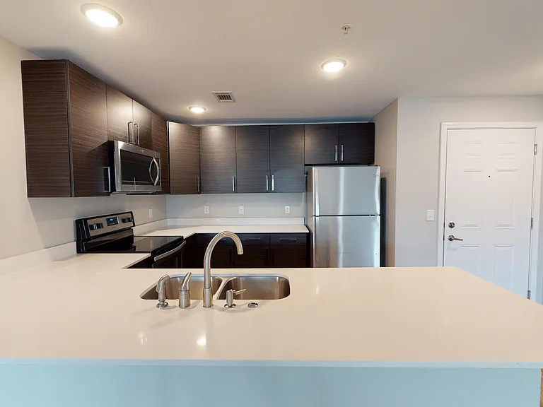 The Walnut floor plan's kitchen features ample counterspace, cabinetry, and stainless steel appliances. The Walnut floor plan's kitchen features ample counterspace, cabinetry, and stainless steel appliances.