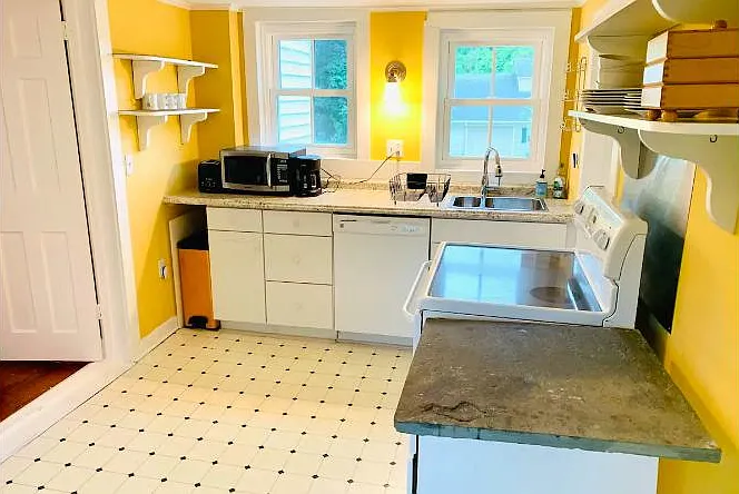 Kitchen with dishwasher, sink, microwave and stove